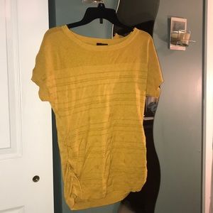 Mustard yellow short sleeve shirt.